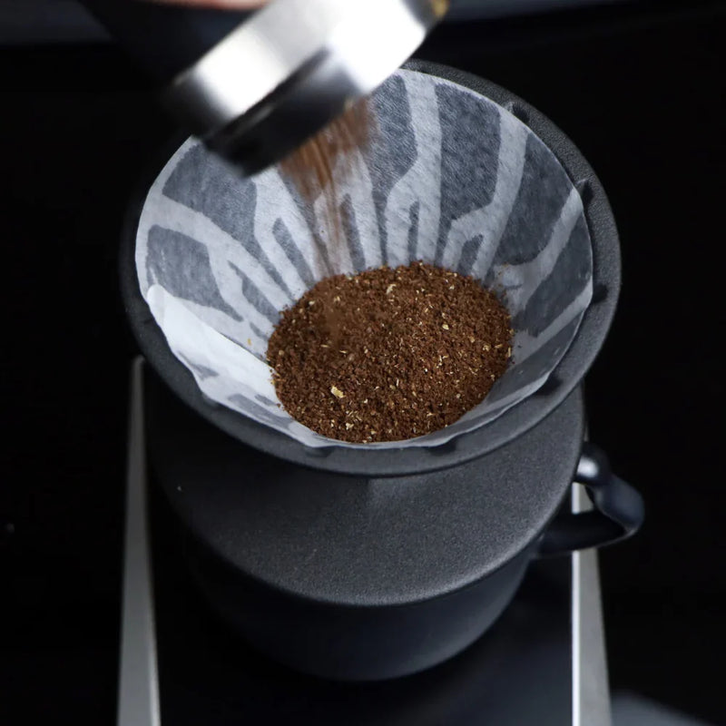 Load image into Gallery viewer, The Hario Alpha coffee dripper in matte black, featuring a minimalist cone-shaped design for manual pour-over brewing.