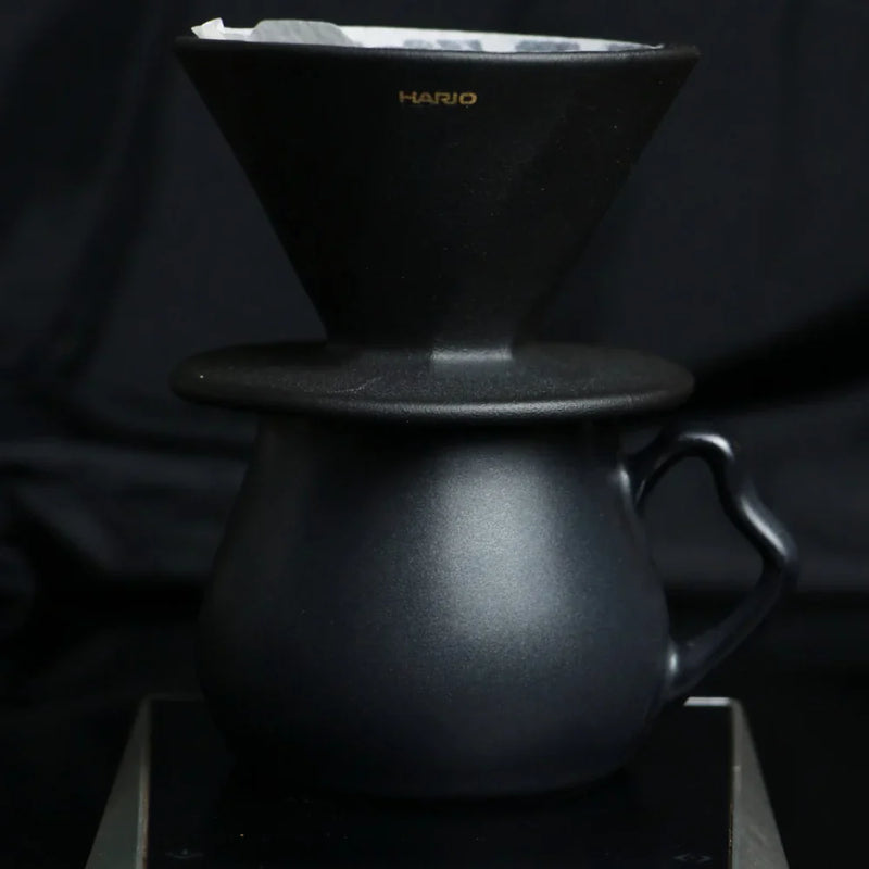 Load image into Gallery viewer, The Hario Alpha coffee dripper in matte black, featuring a minimalist cone-shaped design for manual pour-over brewing.