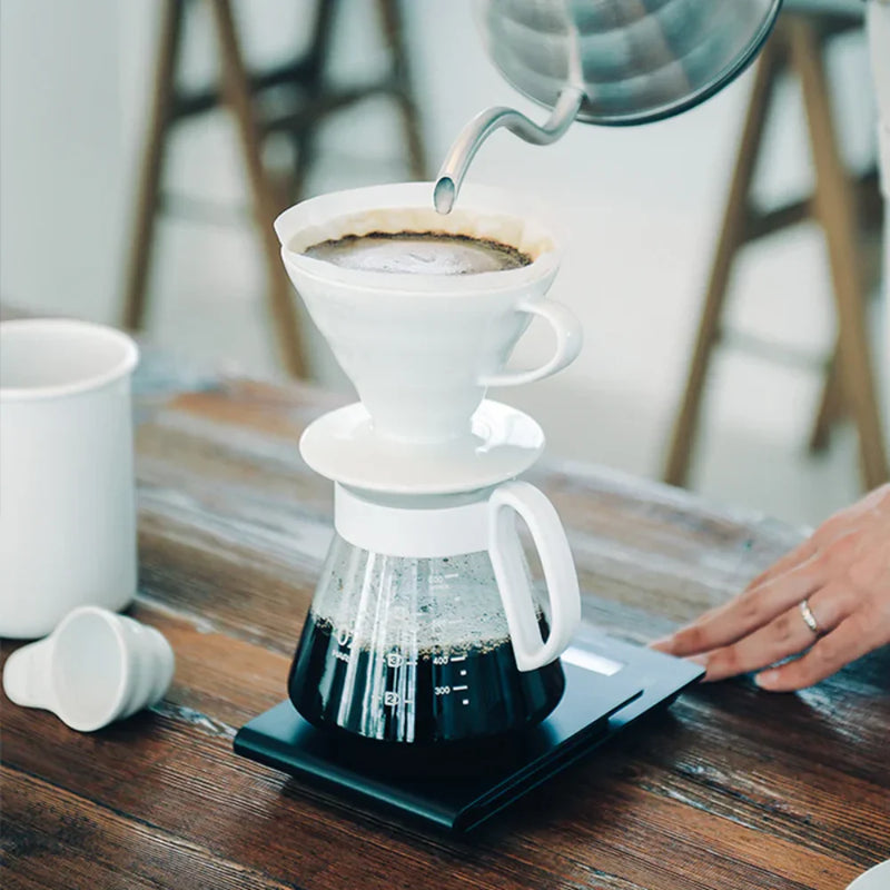 Load image into Gallery viewer, White ceramic Hario V60 pour-over set with a size 02 dripper for superior heat retention and a heatproof glass carafe.
