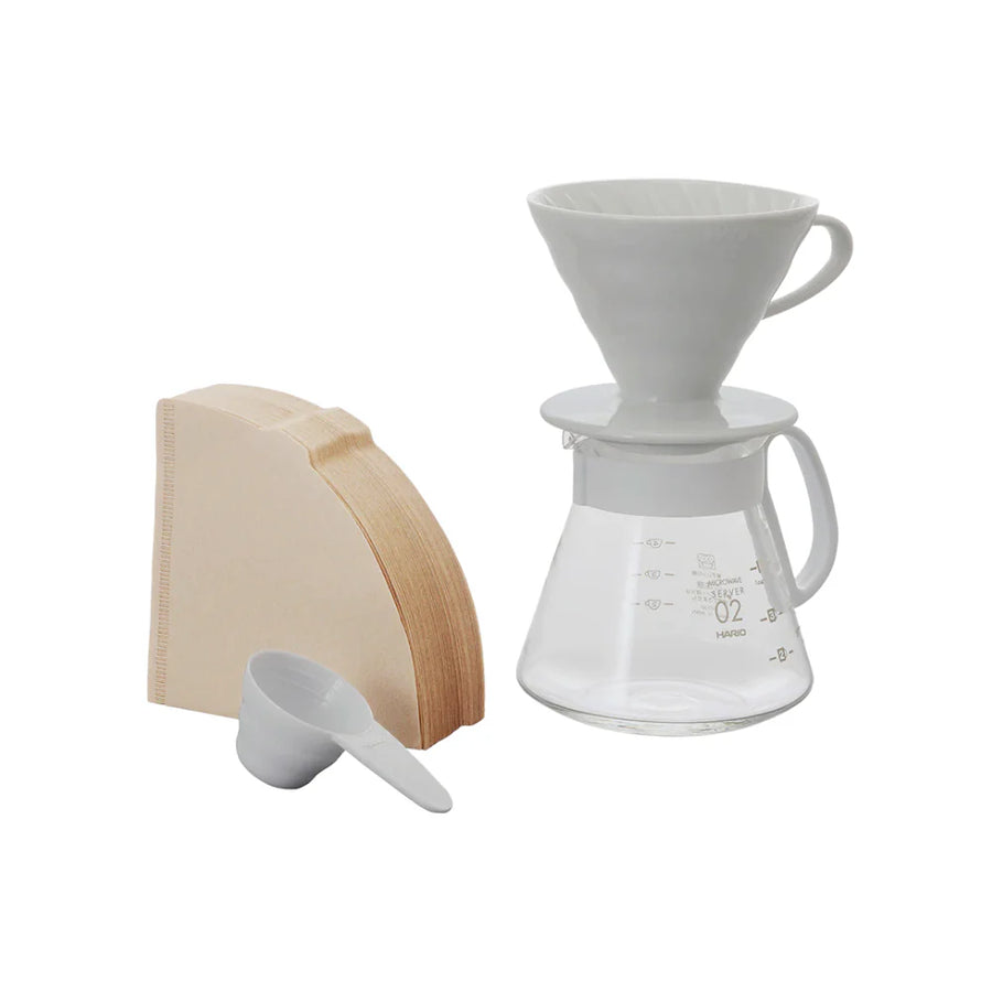 White ceramic Hario V60 pour-over set with a size 02 dripper for superior heat retention and a heatproof glass carafe.